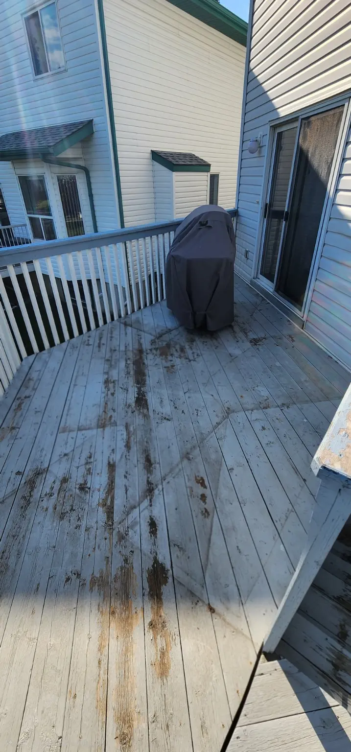 Grey weathered deck before cleaning in Calgary