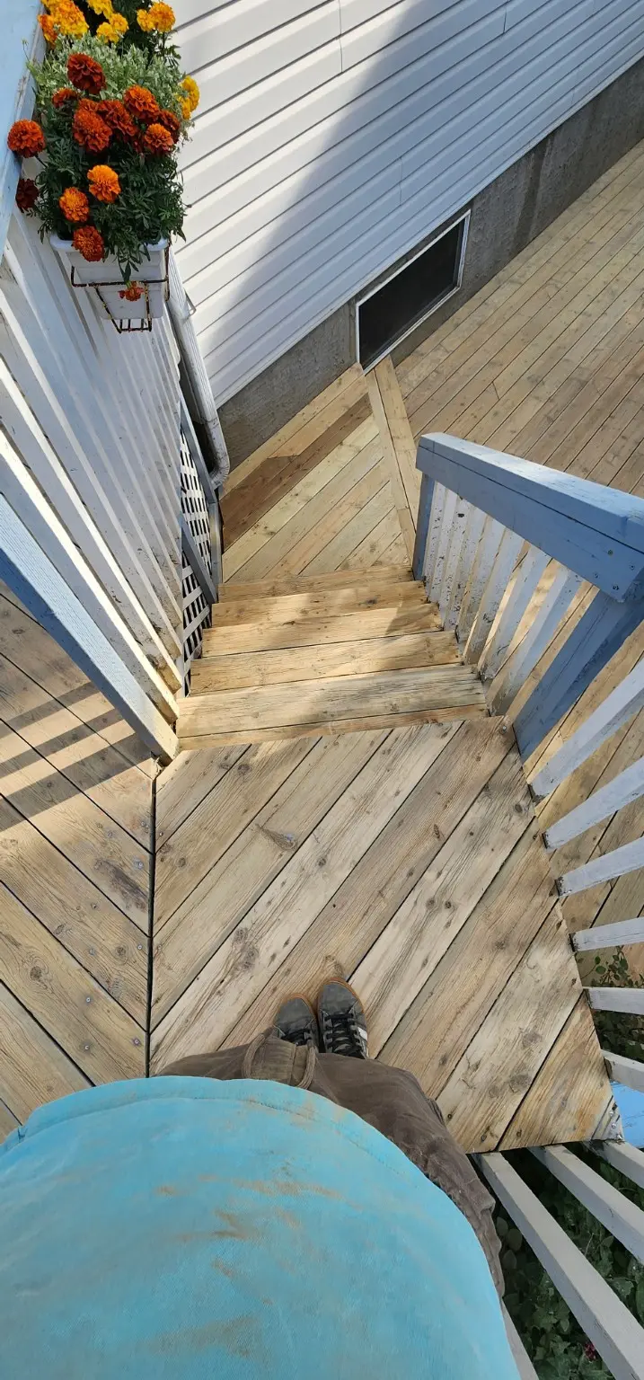 Wood deck stairs prepared for refinishing in Calgary by White5