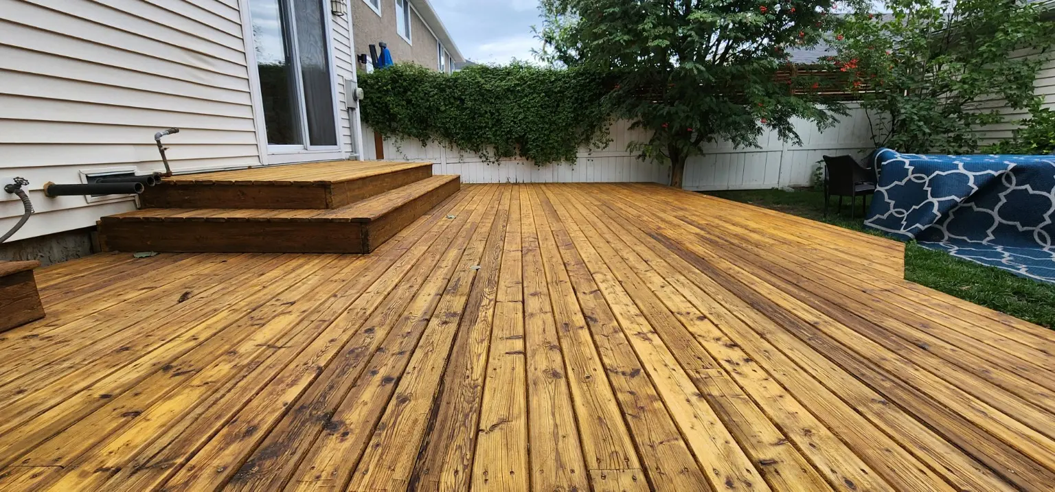 Large backyard deck restored by White5 in Calgary