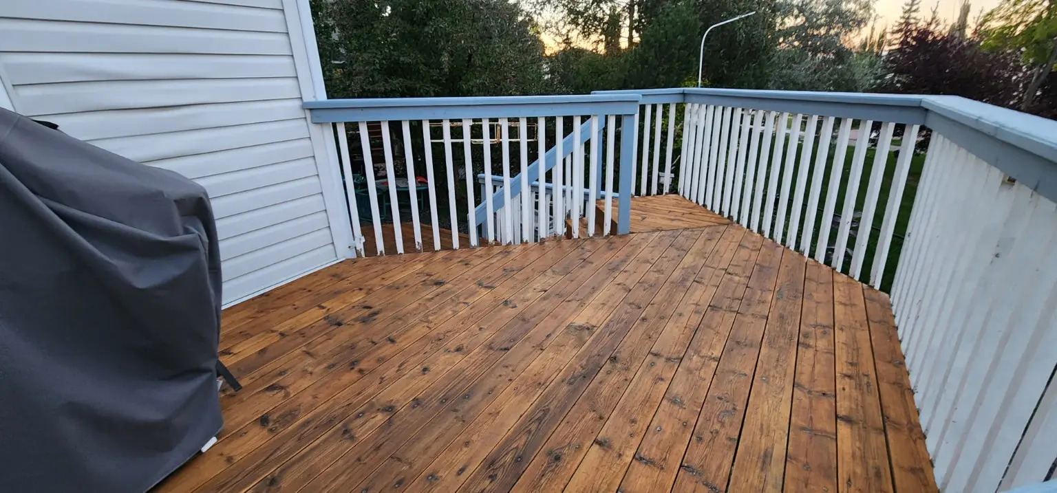 Upper wood deck restored and stained by White5 in Calgary