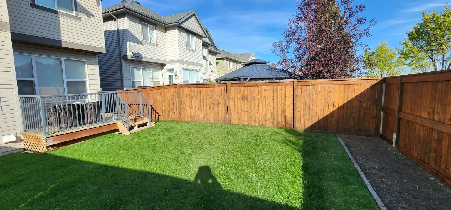 Restored backyard wood fence by White5 in Calgary
